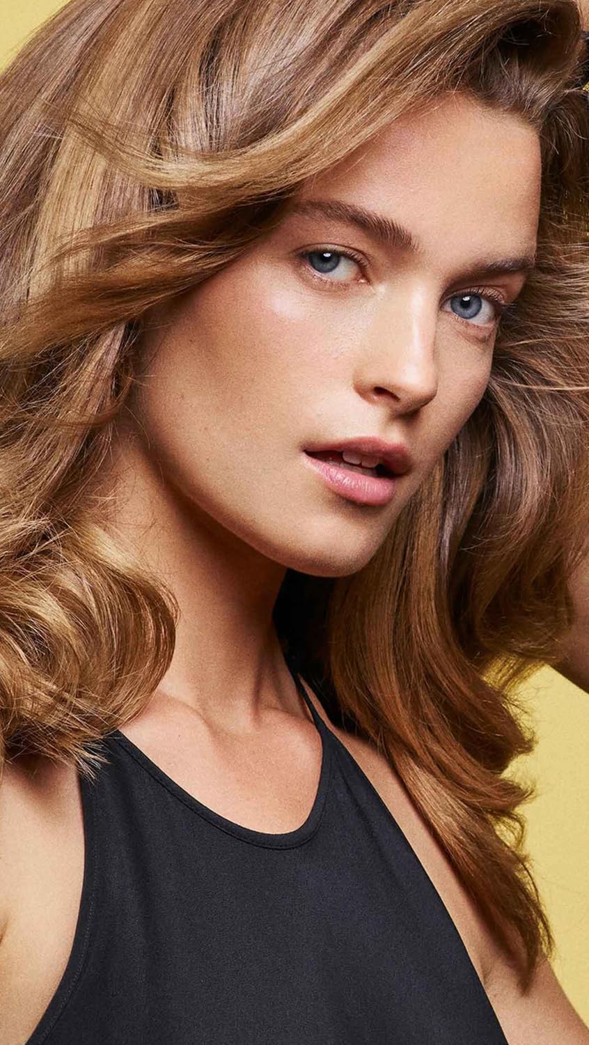 In-shower application of Oribe conditioner showing detangling benefit