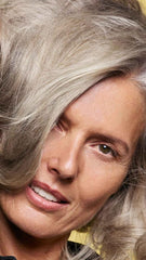 Oribe Hair Alchemy staged in bathroom lifestyle shot showing daily routine