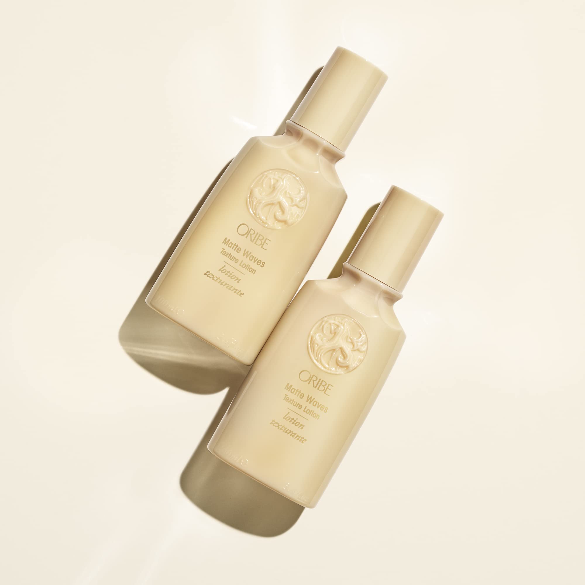 Oribe Matte Waves tube in hand for scale and portable styling benefit