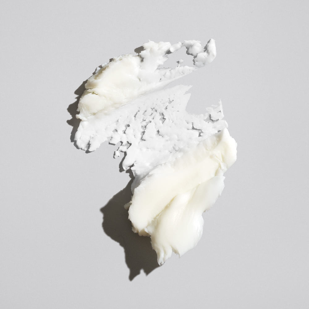 Oribe paste texture close-up showing smooth creamy wax for even distribution