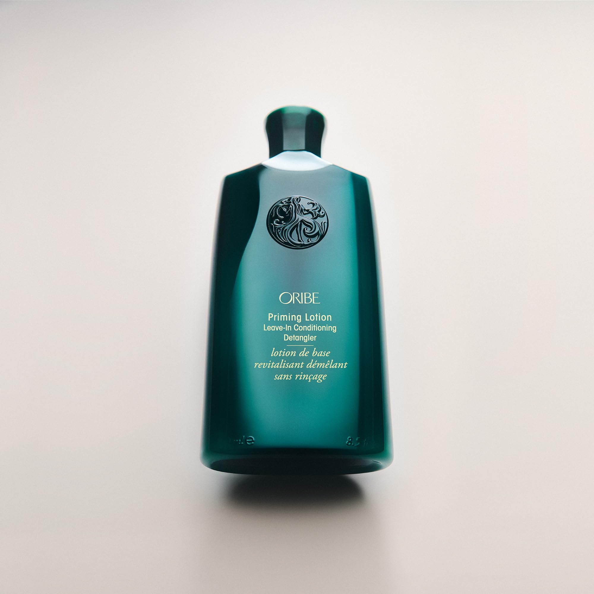 Oribe Priming Lotion label close-up showing color-safe, silicone-free benefits