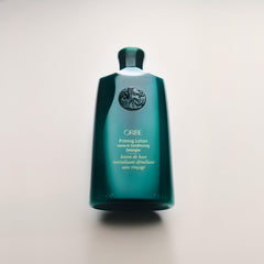 Oribe Priming Lotion label close-up showing color-safe, silicone-free benefits