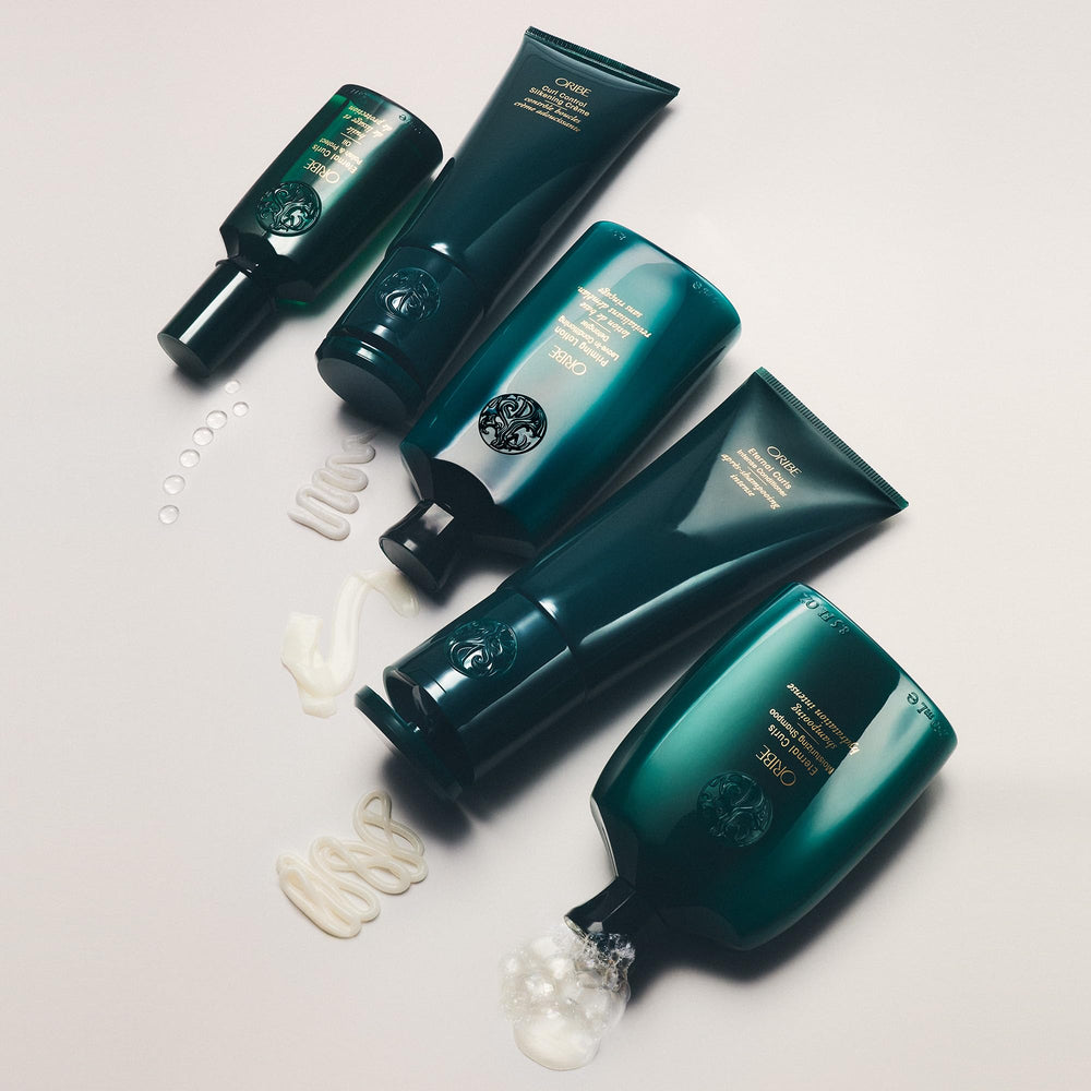 Oribe Priming Lotion finished styled curls in lifestyle scene showing soft touchability
