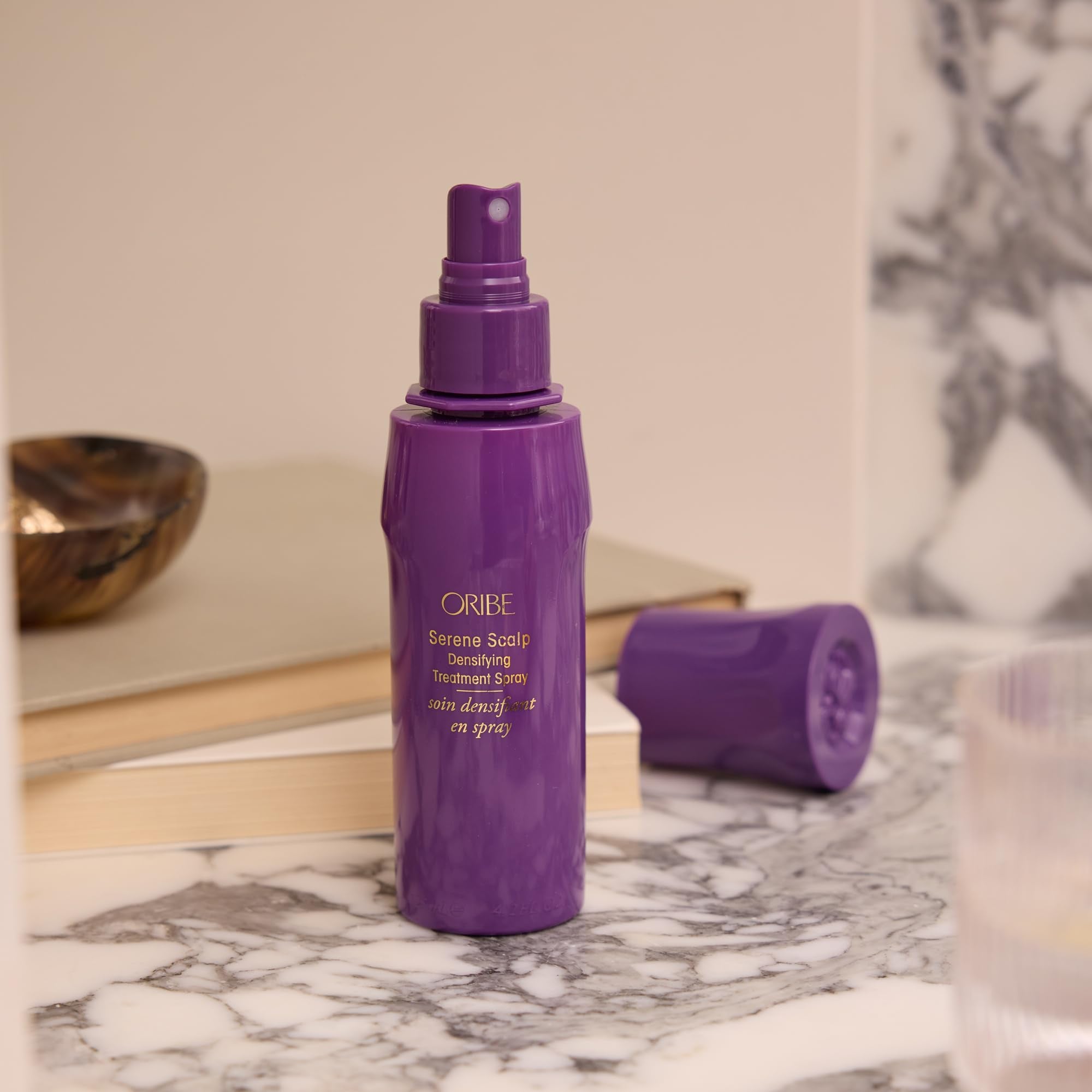 Oribe before and after styling showing fuller-looking hair benefit