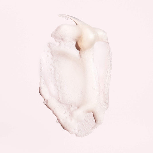Oribe shampoo texture close-up demonstrating gentle cleansing