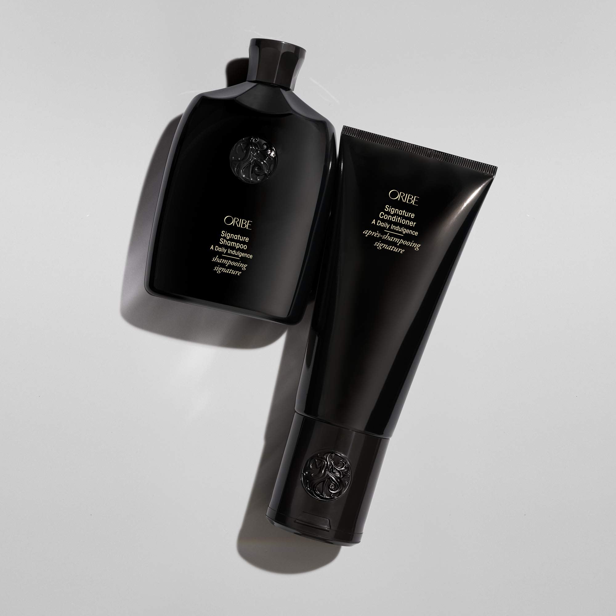 Oribe signature conditioner applied in shower demonstrating detangling and softness benefit