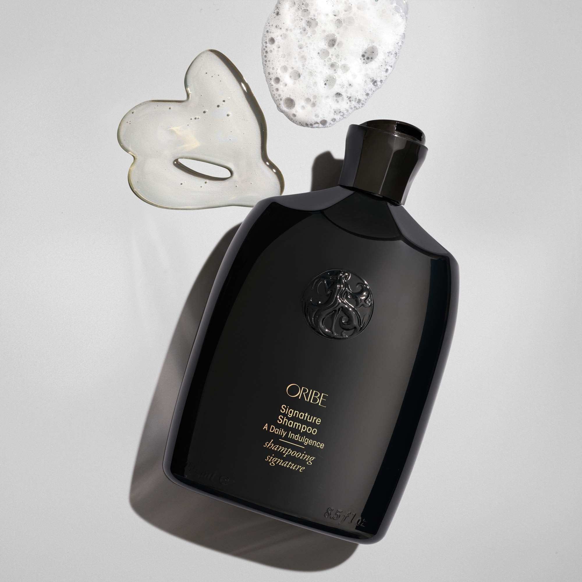 Oribe signature shampoo label close-up highlighting ingredients and treatment-safe benefit
