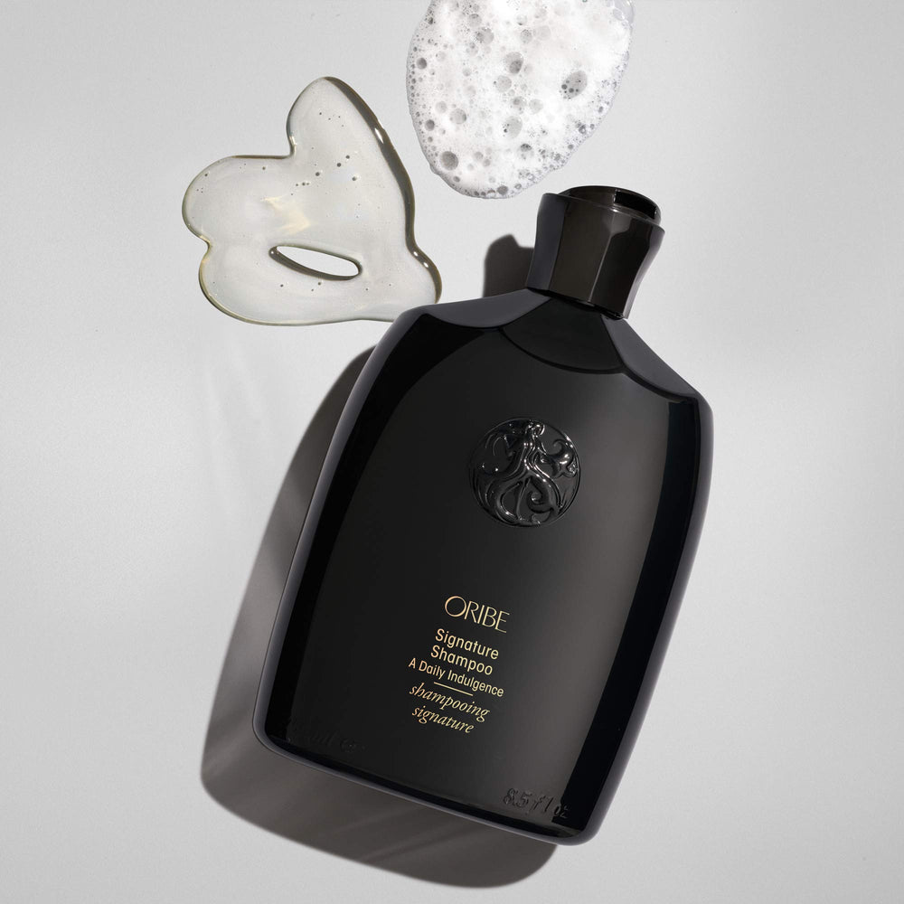 Oribe signature shampoo label close-up highlighting ingredients and treatment-safe benefit