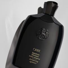 Oribe signature shampoo open cap with foam illustrating easy dispensing benefit