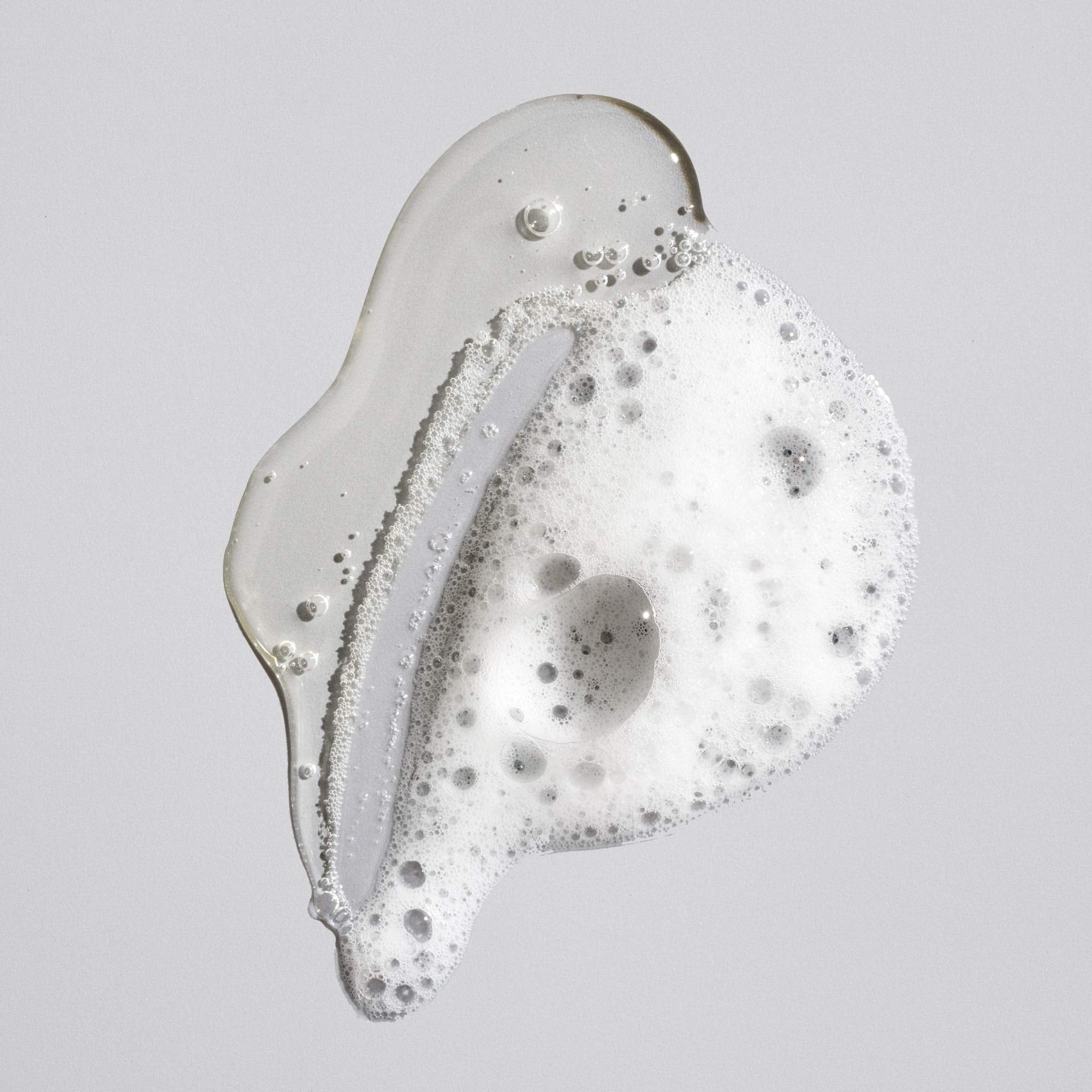Oribe signature shampoo creamy lather close-up demonstrating gentle cleansing benefit