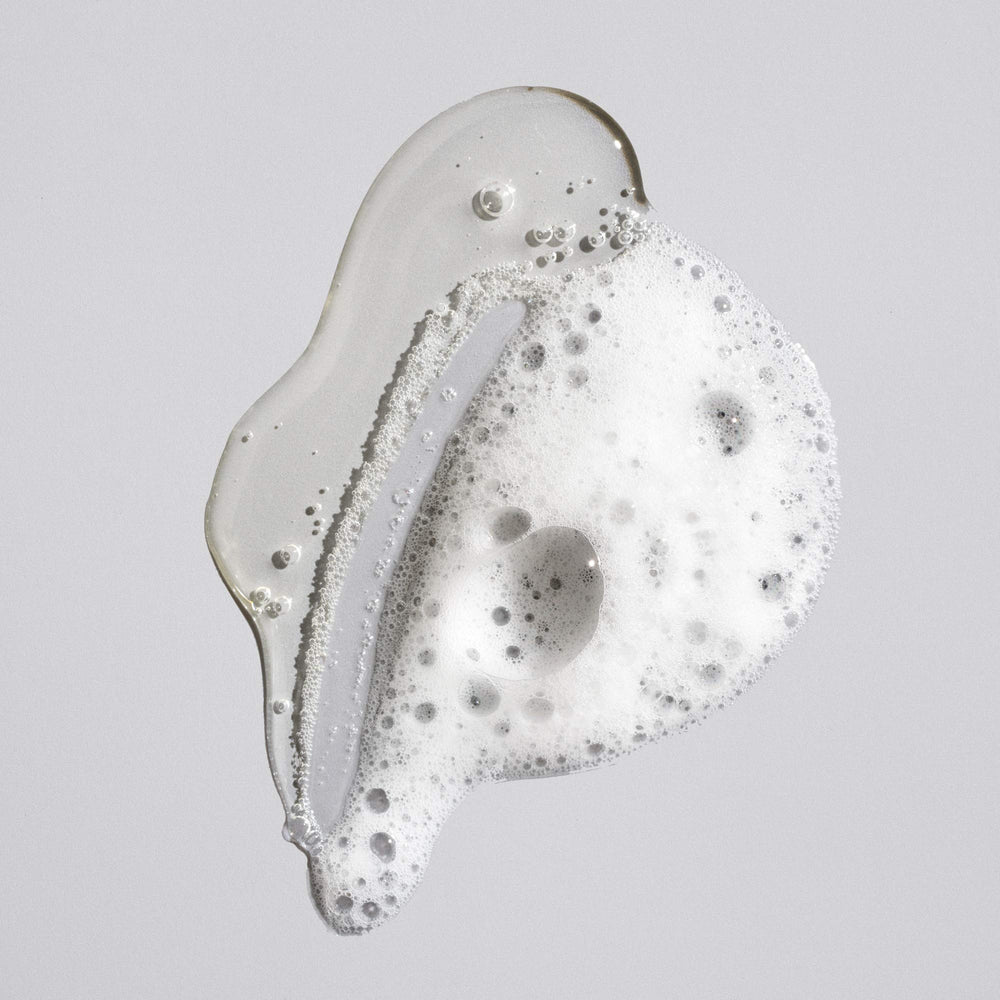 Oribe signature shampoo creamy lather close-up demonstrating gentle cleansing benefit