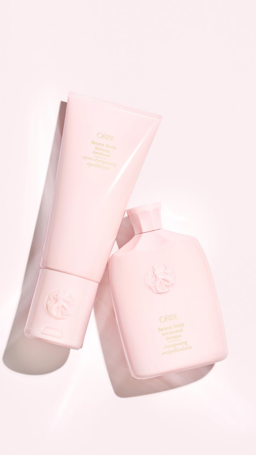 Oribe 6.8 fl oz conditioner held in hand showing compact size and convenient travel benefit