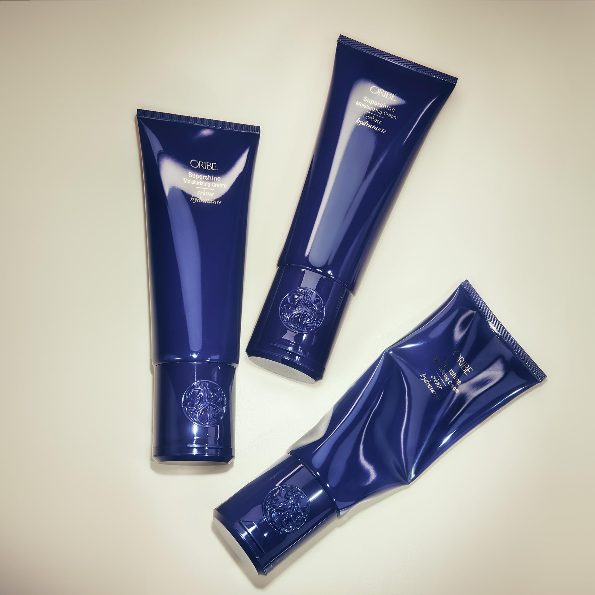 ORIBE tube on bathroom shelf styled with other products conveying daily luxury routine