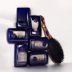 Oribe Supershine tucked into travel pouch as part of a portable styling kit