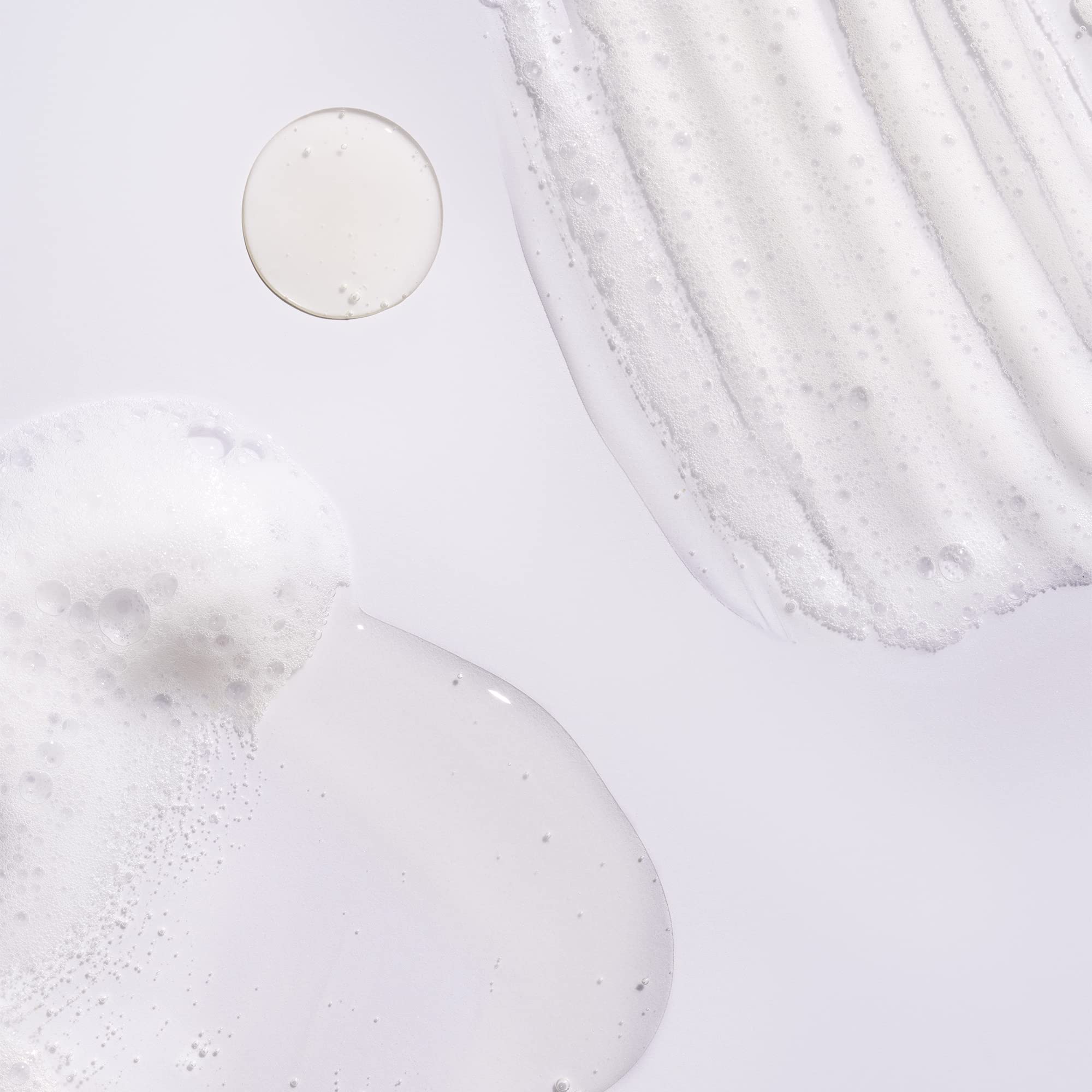 ORIBE shampoo lather texture close-up highlighting gentle cleansing action