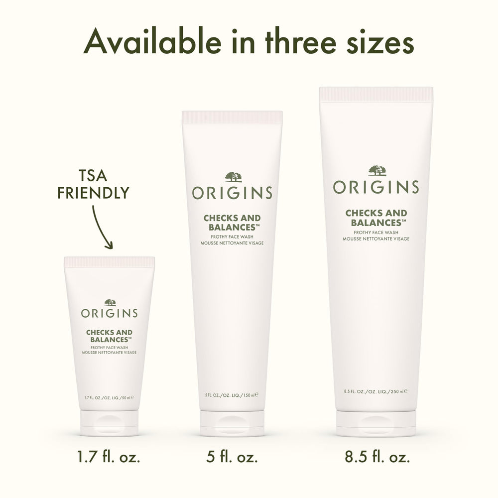 Origins bottle beside spearmint leaves emphasizing minty freshness benefit