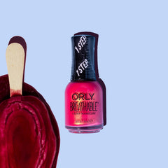 Orly The Floor Is Lava swatch on fingertips displaying full coverage color