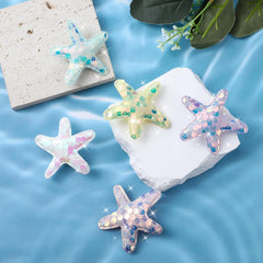 Oruola starfish clip beside coin showing compact 6x6 cm size advantage