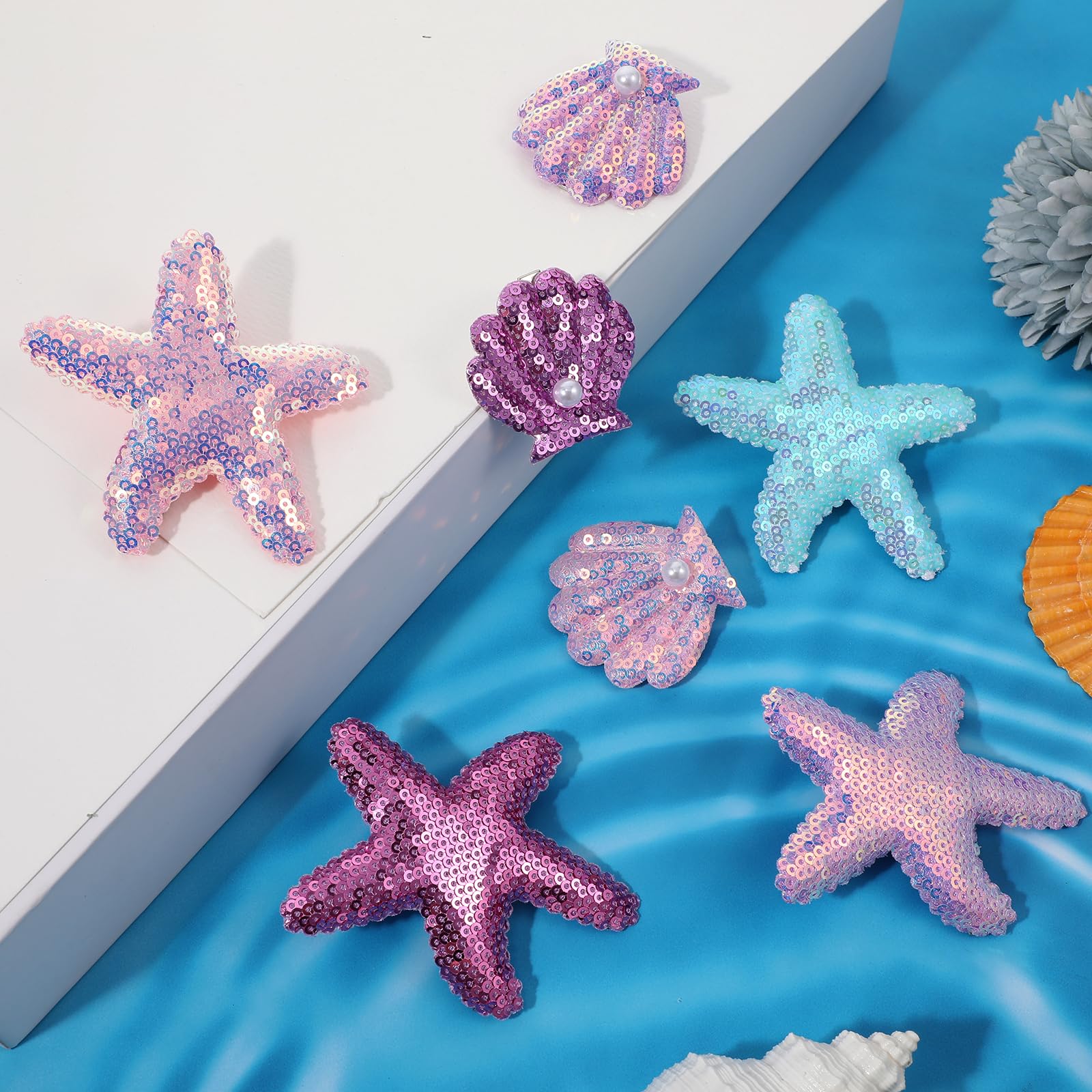 oruola size comparison with ruler showing starfish and seashell measurements