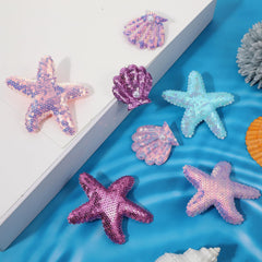 oruola size comparison with ruler showing starfish and seashell measurements