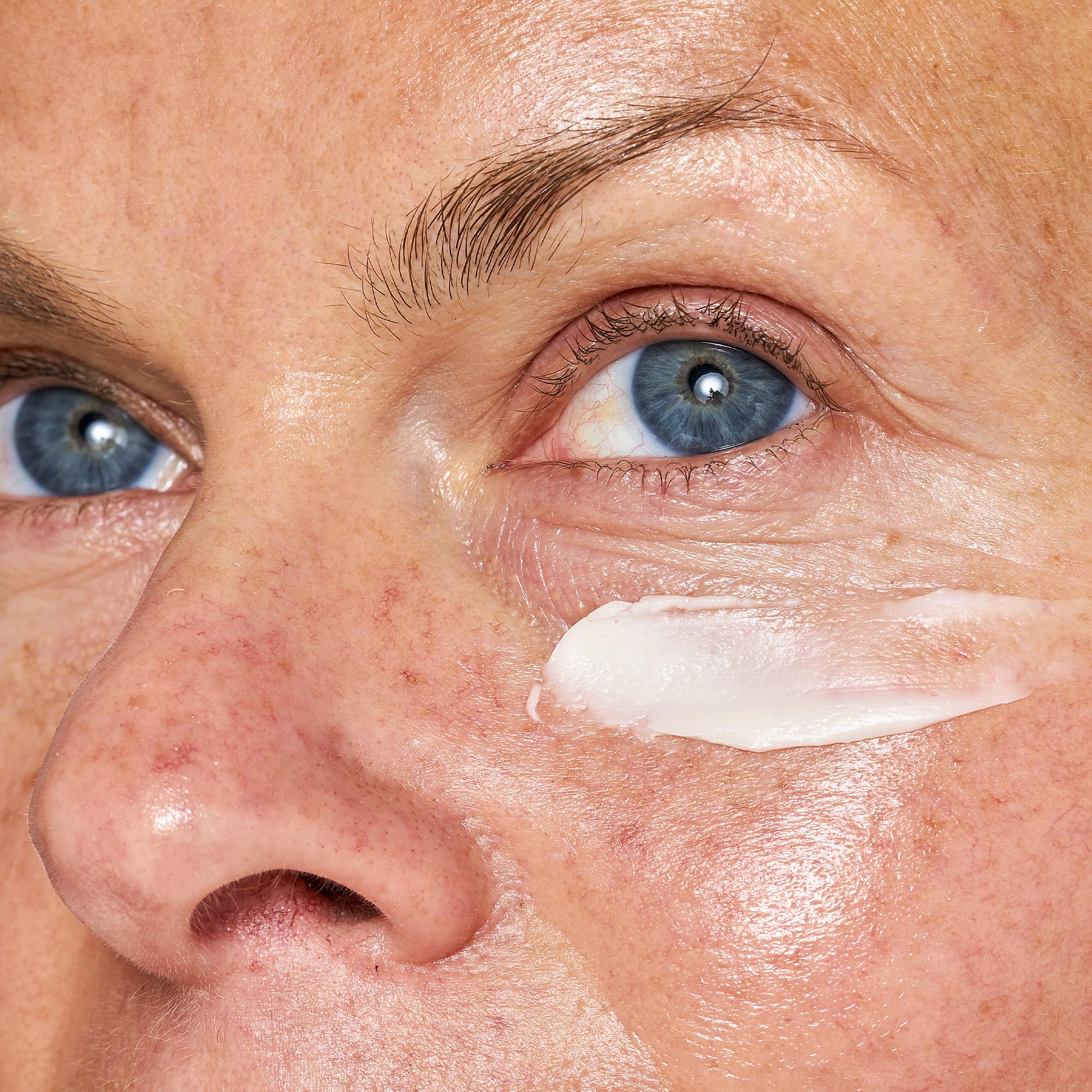 OSEA applying eye cream on hand to demonstrate lightweight spread and absorption