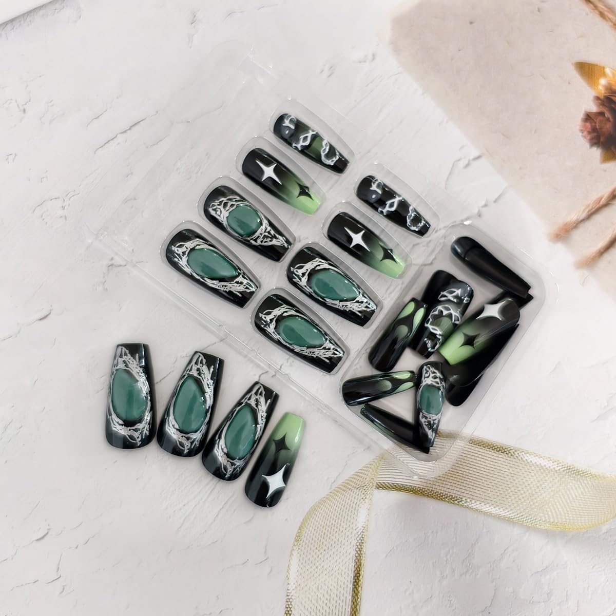 OSTTMA press-on nails worn on hands with dark outfit demonstrating finished look