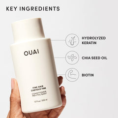 OUAI 32 oz refill held in hand to show scale and refill convenience
