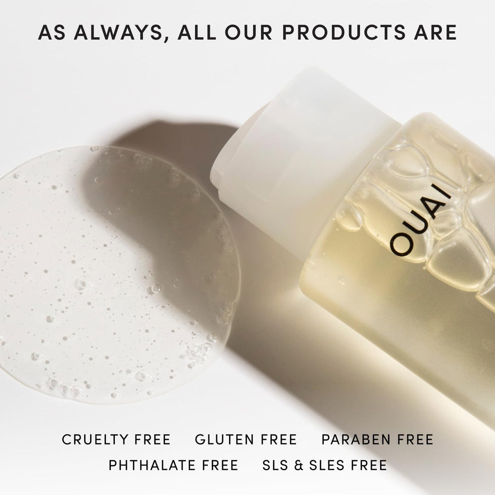OUAI 10 oz bottle in hand for scale, showing travel-safe volume