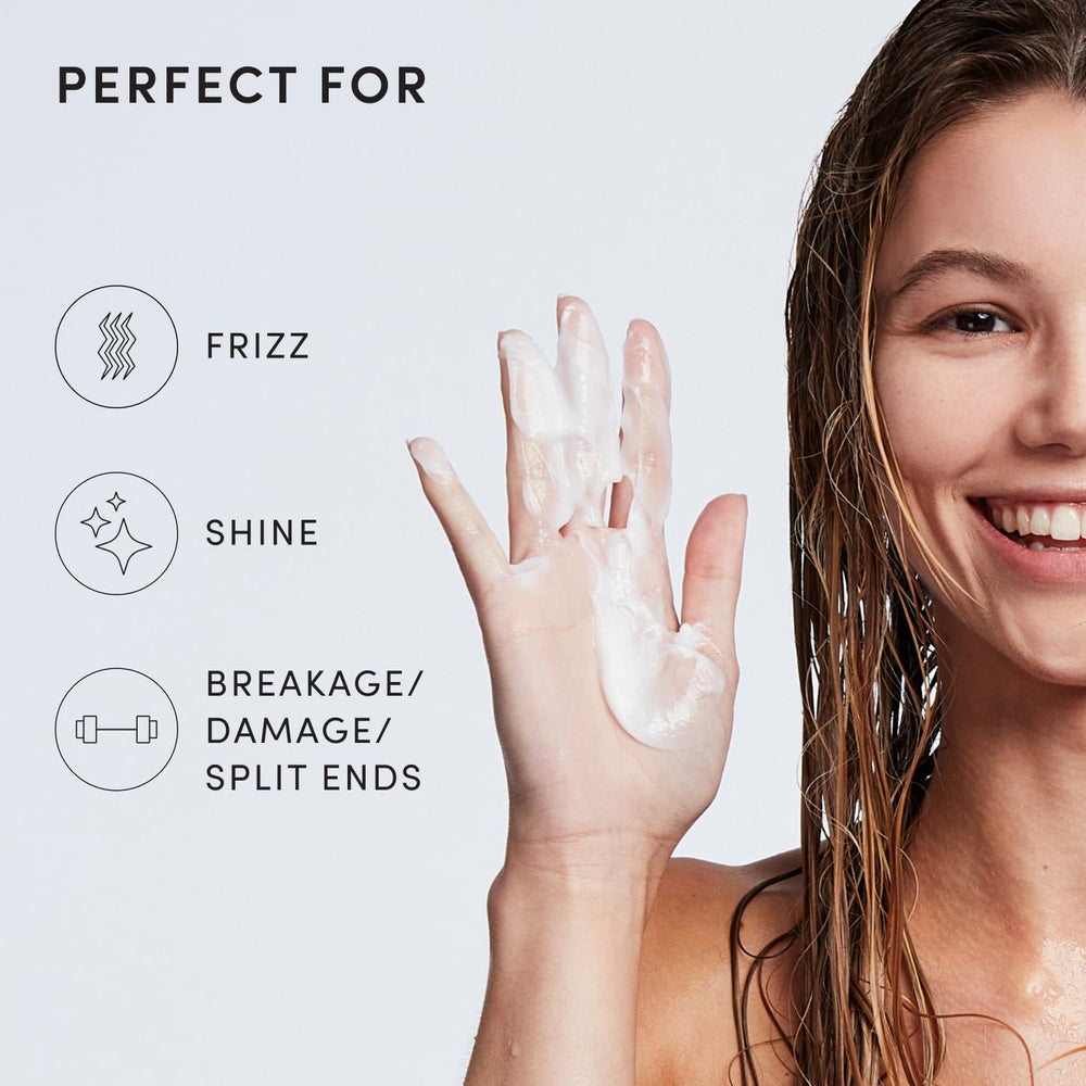 OUAI medium conditioner bottle placed in shower setting to suggest everyday routine use