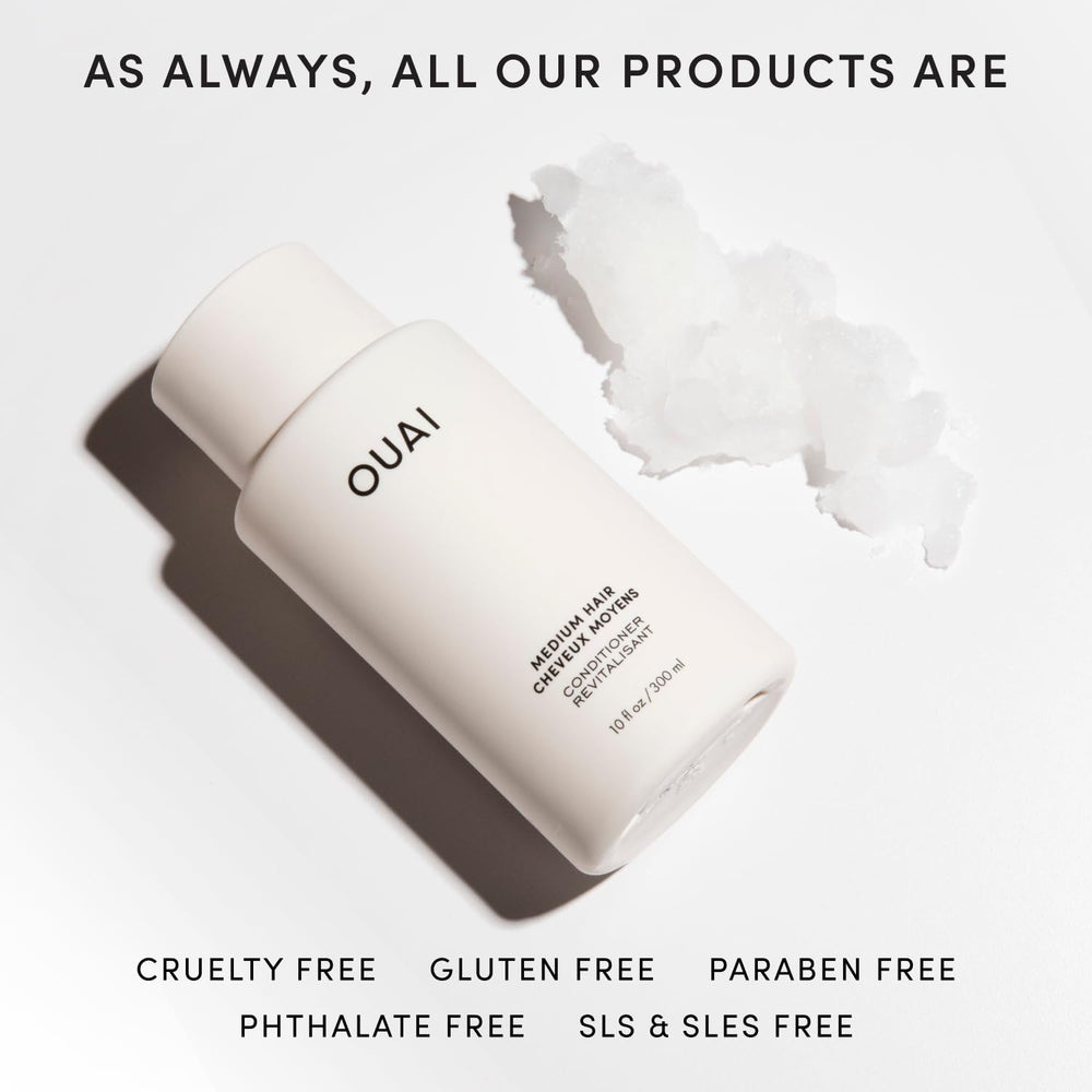 OUAI medium conditioner being applied to wet hair in hand showing easy spread and hydration