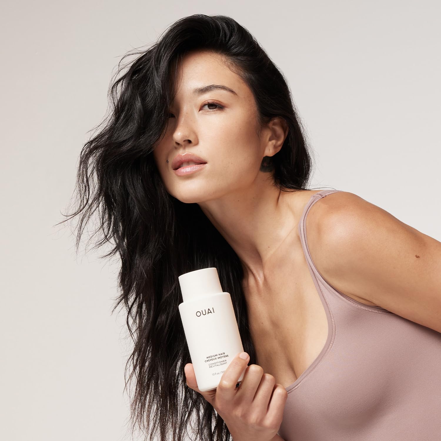 OUAI pump bottle filled from refill pouch, convenient refill system benefit