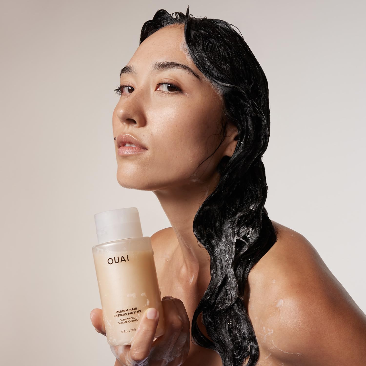 OUAI medium shampoo rich lather texture demonstrating gentle yet effective cleanse