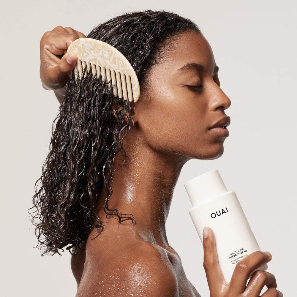 OUAI product being poured to refill a bottle for less waste