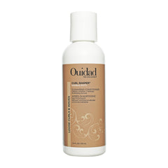 Ouidad travel bottle front view showing compact size and brand