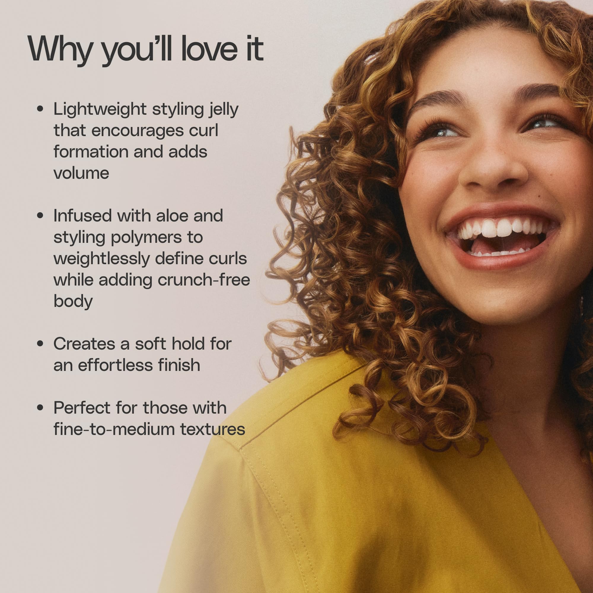 Model using Ouidad while diffusing fine loose curls for added lift