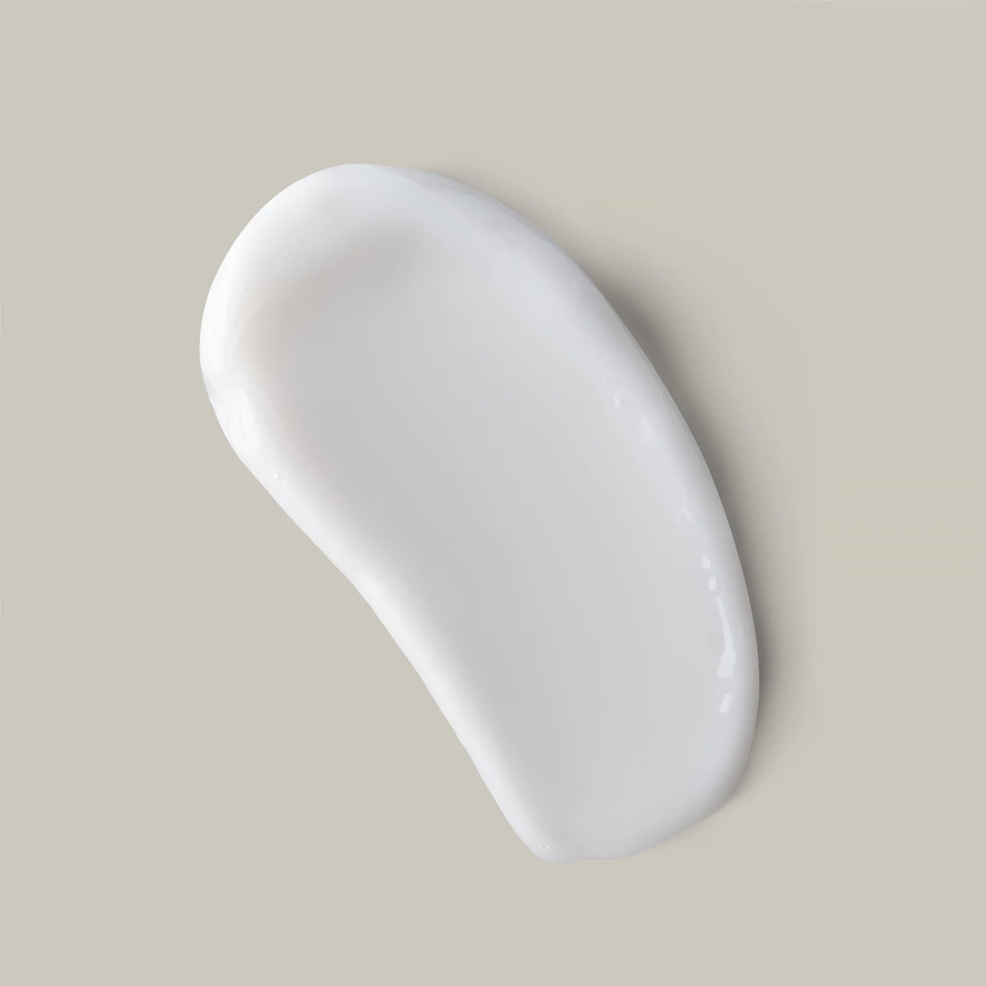 Hand scooping Ouidad curl butter showing easy application and control