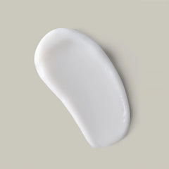 Hand scooping Ouidad curl butter showing easy application and control