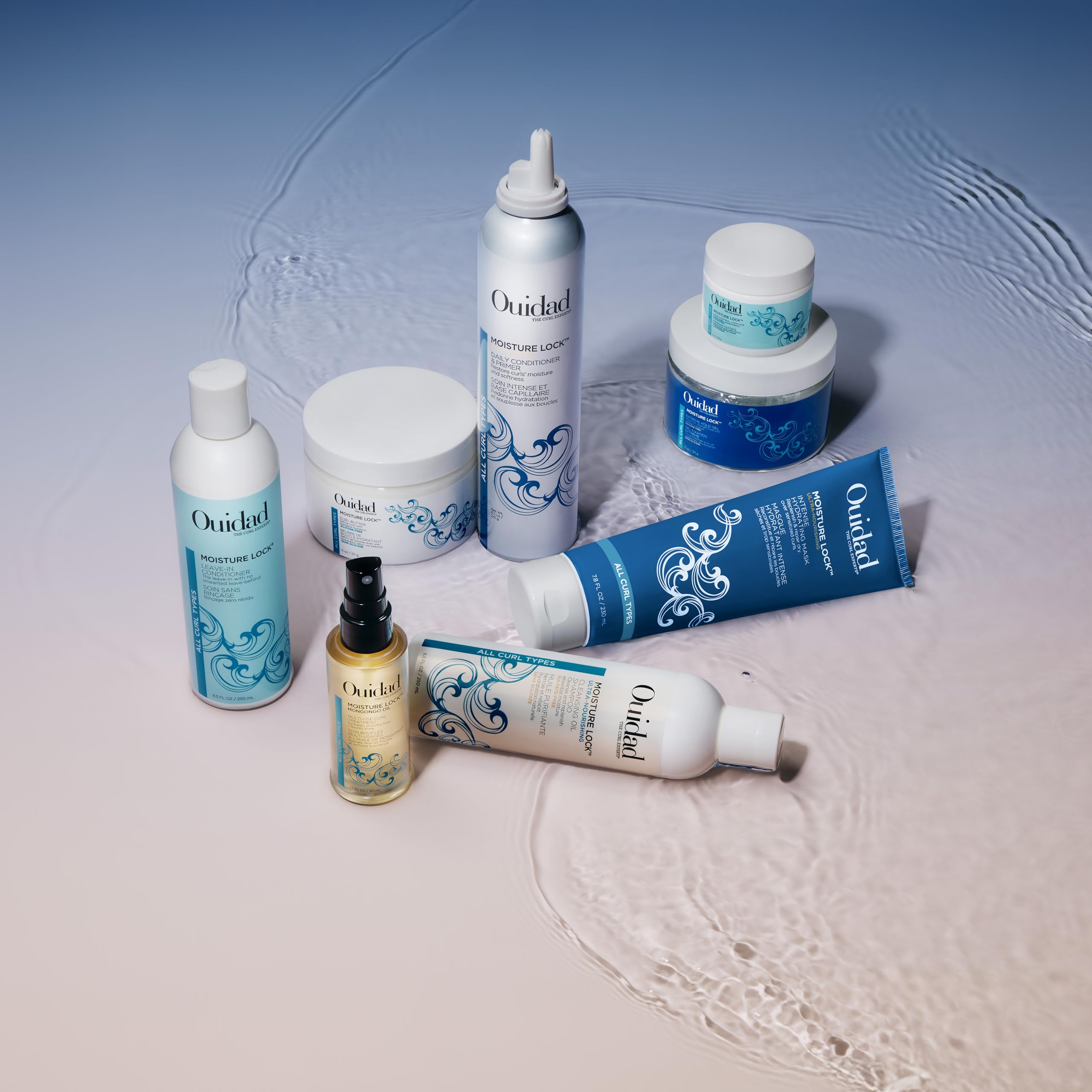 Smiling model with hydrated defined curls after Ouidad mask highlighting frizz control benefit