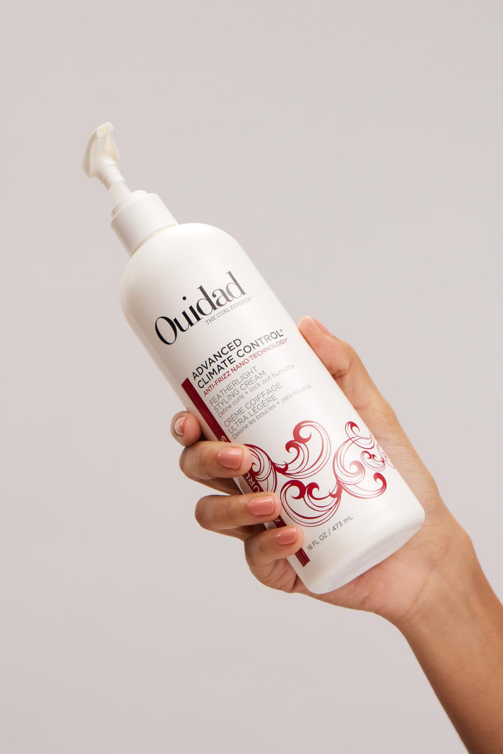 Ouidad 16 fl oz size comparison against common bottle for scale