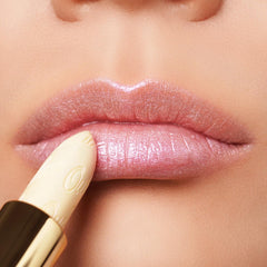 Oulac lipstick held in hand to show size and handbag-friendly portability
