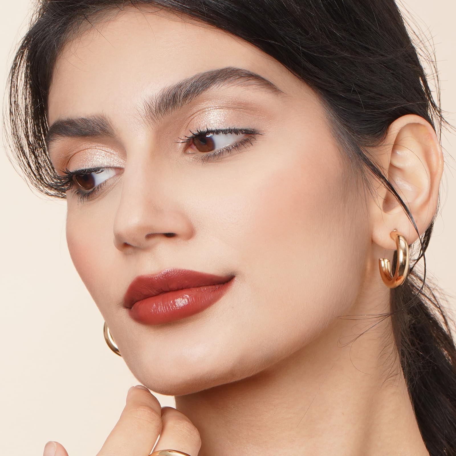 Oulac lipstick open showing creamy satin texture and smooth application benefit