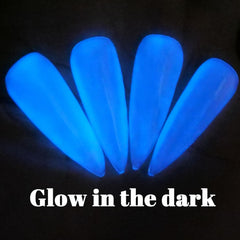 Oumisaya glowing blue nails in darkness, demonstrating the bright nocturnal glow effect