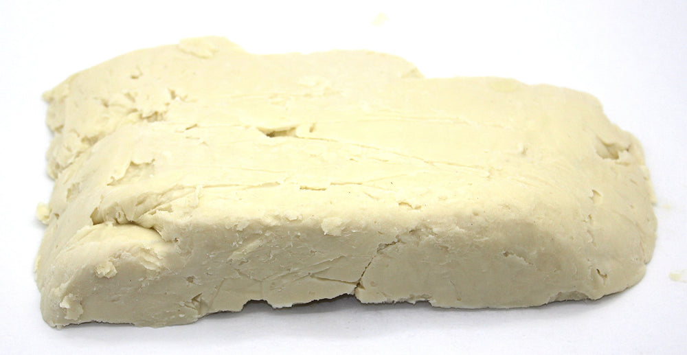 Our Earth's Secrets close-up of shea butter texture revealing creamy granules for smooth blending