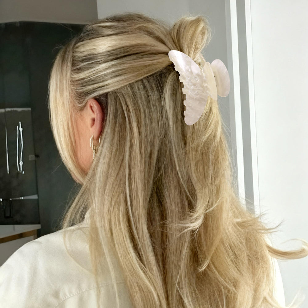 OWIIZI styled with outfit on table illustrating fashion versatility