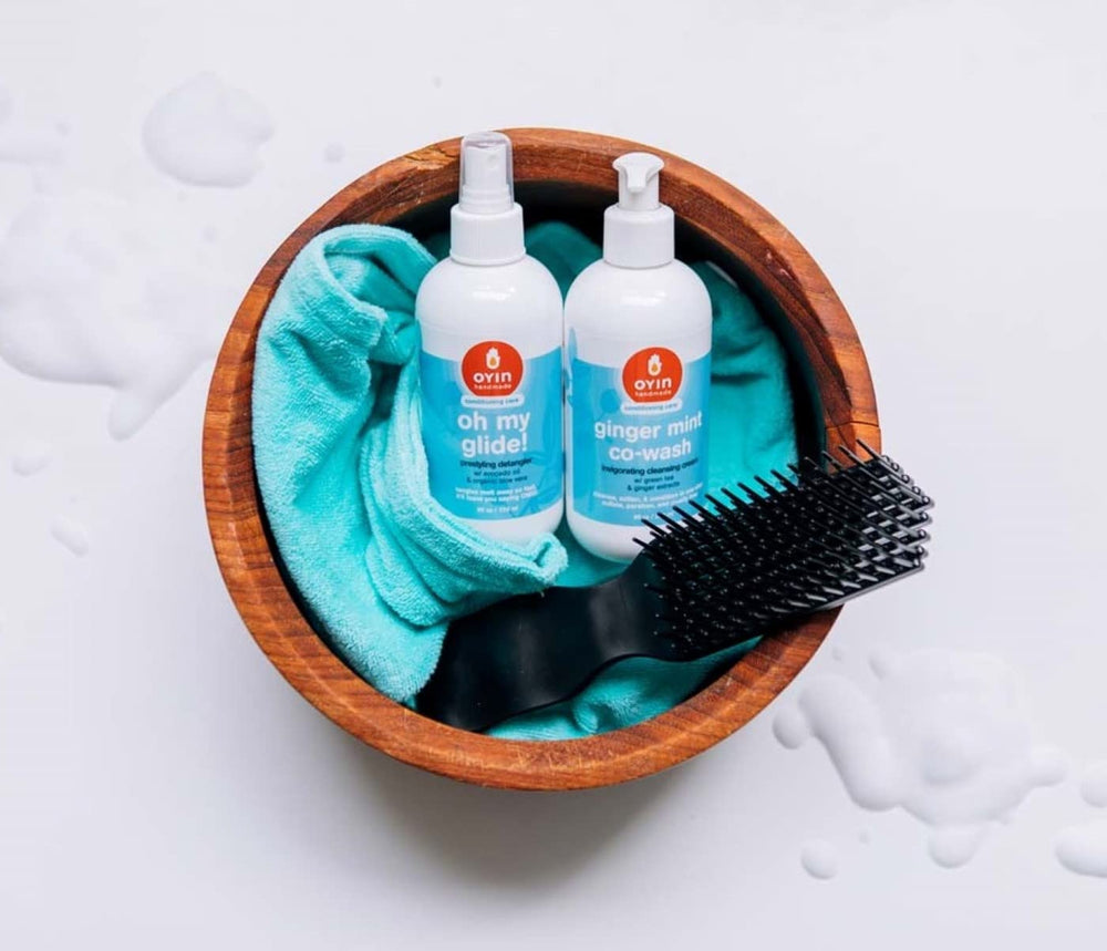 Oyin Handmade ginger mint co-wash in a bathroom routine being applied to wet curly hair for scalp refresh