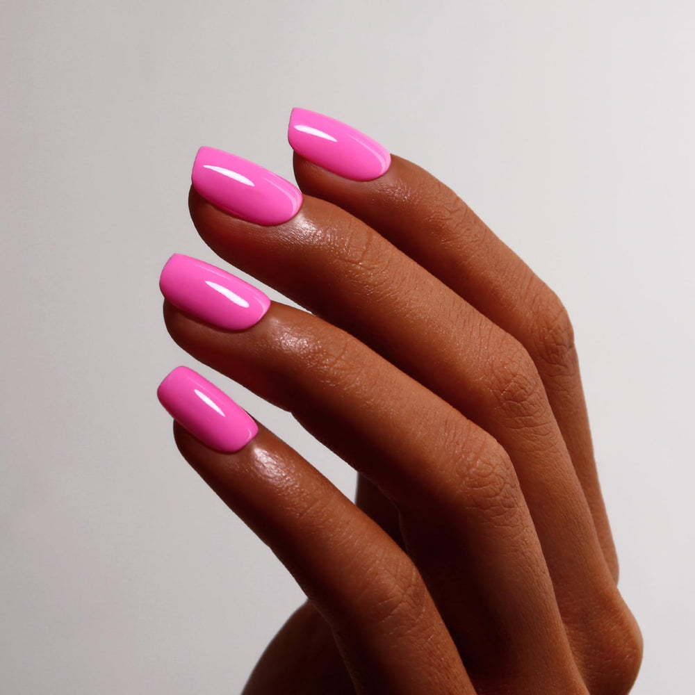 Ozzeal bottle next to nails curing under LED lamp, fast salon-style cure