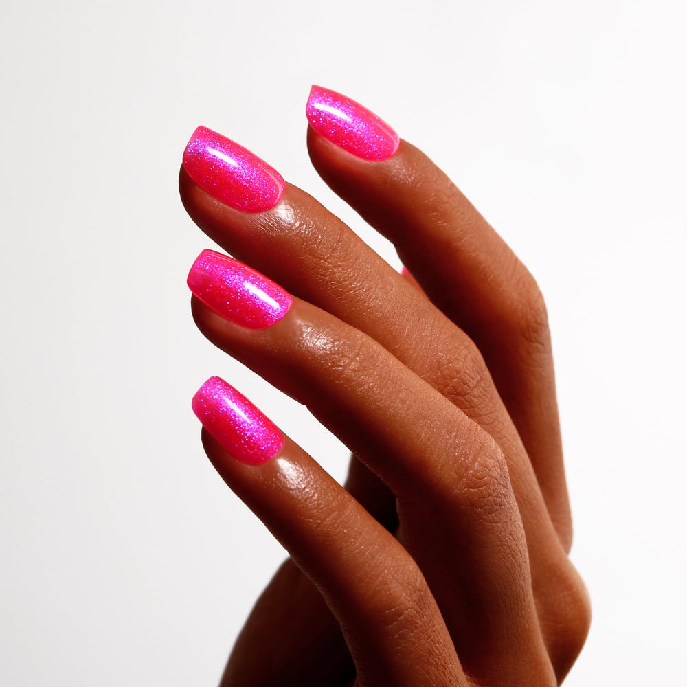 Ozzeal cured nail on model hand showing glossy iridescent finish and durable shine
