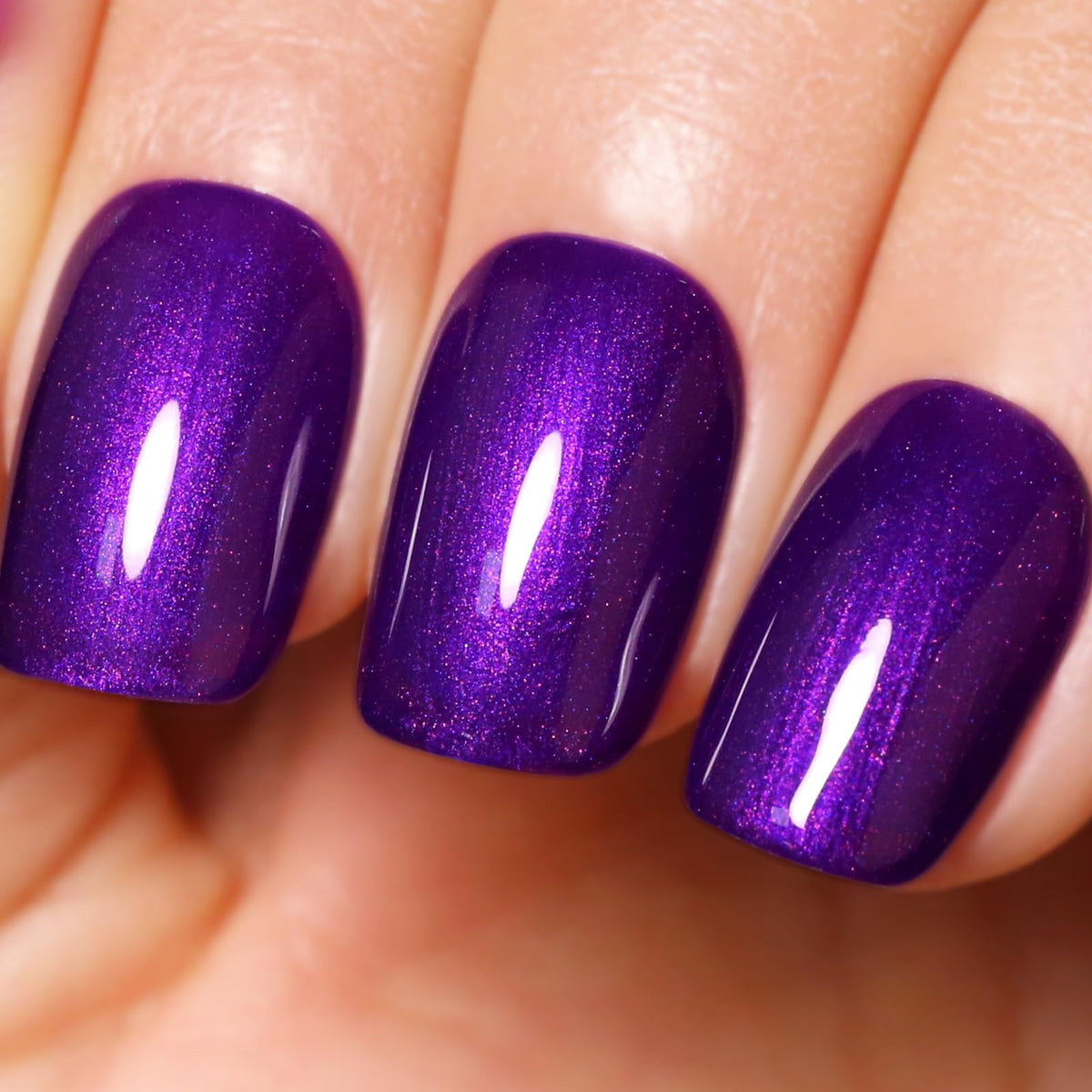 ozzeal bottle front view showing deep purple glitter and glossy finish benefit
