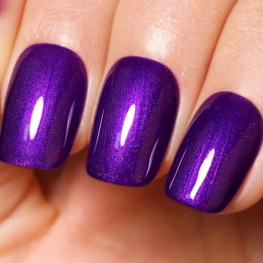 ozzeal bottle front view showing deep purple glitter and glossy finish benefit