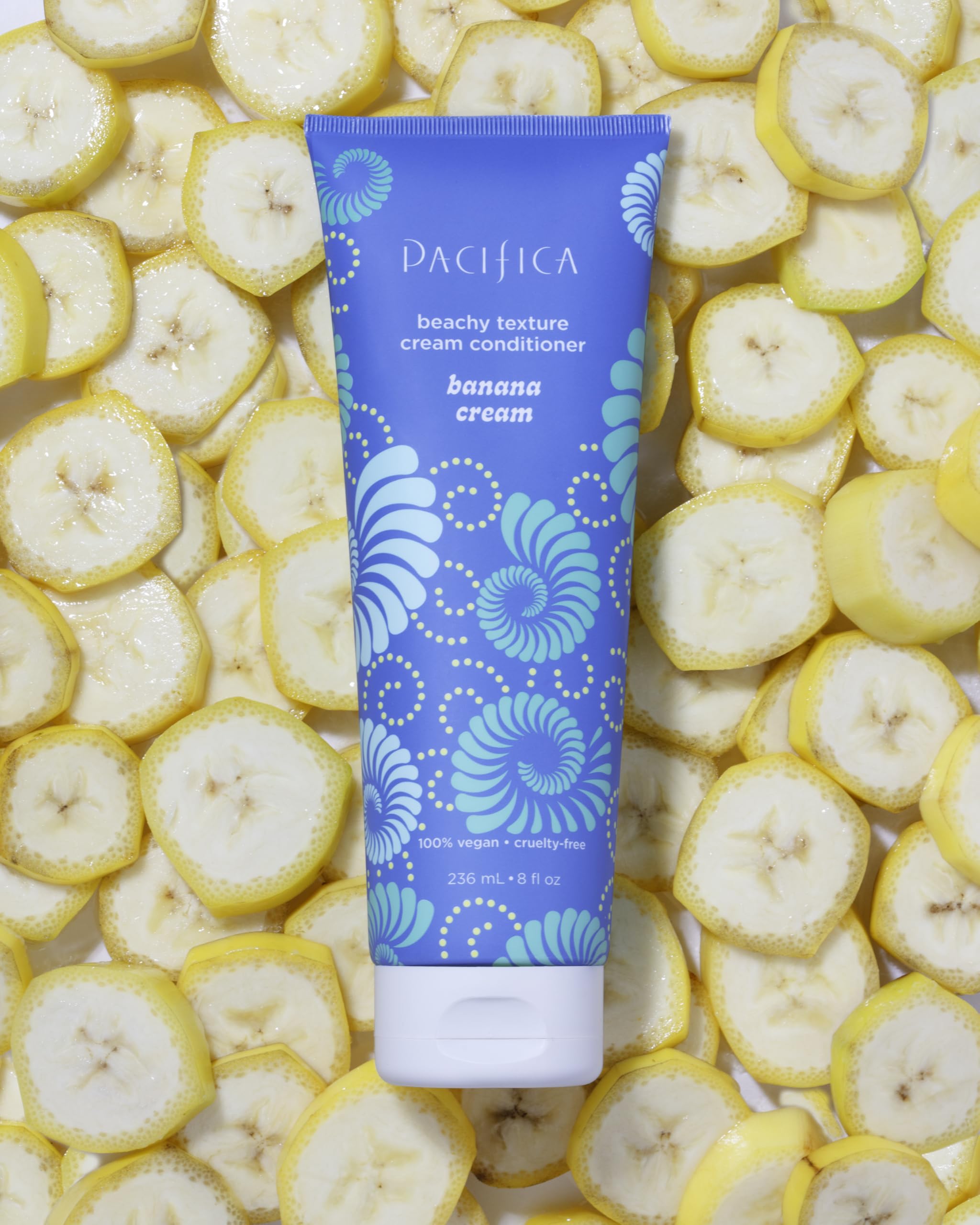 Pacifica bottle placed near tropical decor suggesting uplifting banana scent